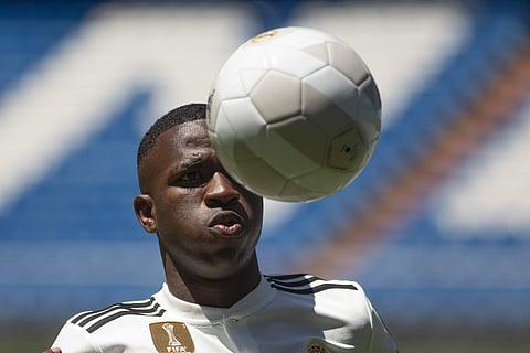 Brazilian new Real Madrid soccer player Vinicius Jr plays the ball for the media during his official presentation for Real Madrid at the Santiago Bernabeu stadium in Madrid. | AP