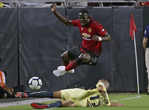 Manchester United defender Eric Bailly, top, has the ball knocked away by Club America defender Luis Reyes (12) during the first half of a friendly soccer match in Glendale Ariz. (Photo | AP)
