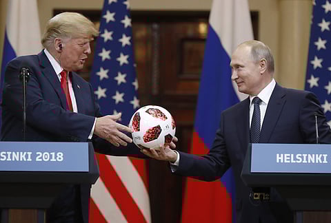 Russian President Vladimir Putin gives a soccer ball to U.S. President Donald Trump, left, during a press conference after their meeting at the Presidential Palace in Helsinki, Finland, Monday, July 16, 2018. | Associated Press