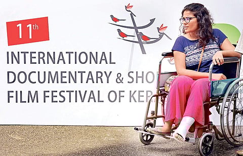 A delegate arrives at Kairali theatre, the venue of International Documentary and Short Film Festival of Kerala on Friday B P Deepu