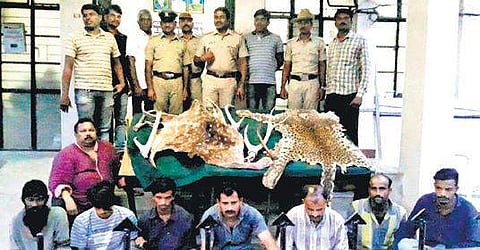 Police with the arrested persons and seized items