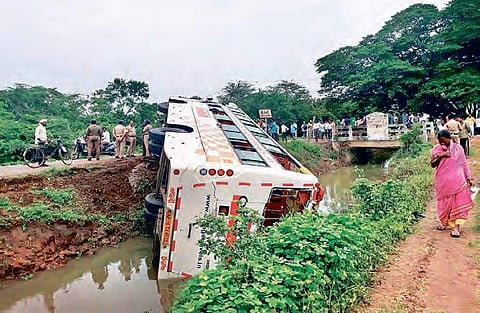 The Orange Travels bus hit a signboard and overturned at Vanapamula village of Pedaparupudi mandal on Sunday | EXPRESS