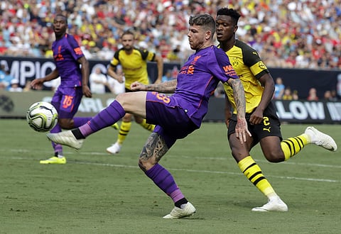 Liverpool's Alberto Moreno (18) tries to drive past Borussia Dortmund's Dan-Axel Zagadou (2) during the second half of an International Champions Cup tournament soccer match. (Photo | AP)