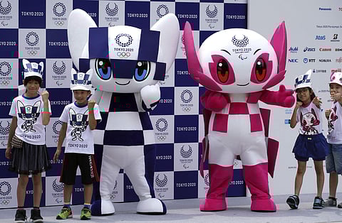 Tokyo 2020 Olympic mascot 'Miraitowa', left, and Paralympic mascot 'Someity', right, pose with children for photographers during the mascot debut event in Tokyo. (File Photo | AP)