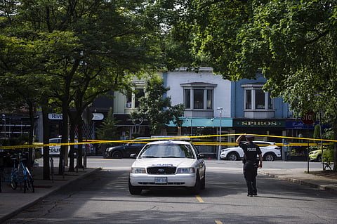 Police are shown at the perimeter of the scene of a shooting in east Toronto, on Monday, July 23, 2018. Police were trying Monday to determine what prompted a 29-year-old man to go on a shooting rampage in a popular Toronto neighborhood. (Photo | AP)