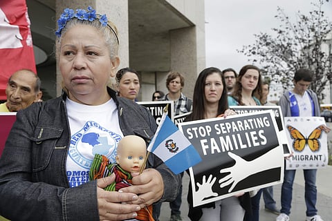 In this file photo, Guatemalan immigrant Amariliz Ortiz holds a doll as she joins families impacted by the immigration raids during a rally with Members of the Coalition for Humane Immigrant Rights of Los Angeles, CHIRLA, outside the ICE Metropolitan Dete