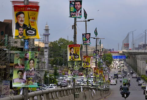 Banners of election candidates from political parties are displayed on poles on a highway in Rawalpindi, Pakistan, July 24, 2018 (Photo | AP)