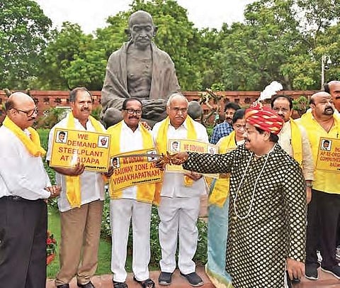 TDP MPs stage a protest on the premises of Parliament in New Delhi on Wednesday demanding special category status for Andhra Pradesh | PTI