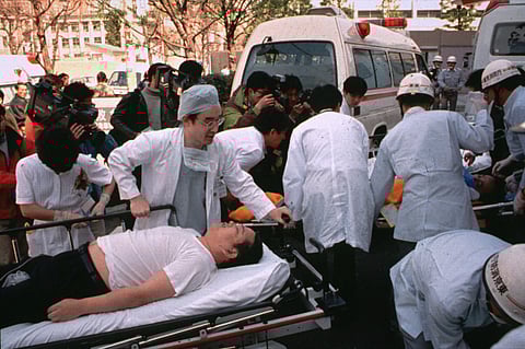In this March 20, 1995 file photo, subway passengers affected by sarin nerve gas in the central Tokyo subway trains are carried into St. Luke's International Hospital in Tokyo. (File Photo | AP)