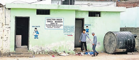Garbage thrown at the entrance of the toilets at Tolichowki Government School on Wednesday | sathya keerthi