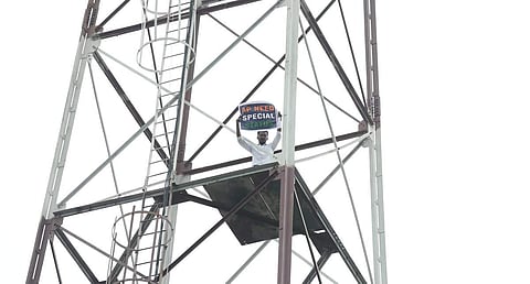 Man atop a tower in Delhi demanding special status for Andhra Pradesh. (Photo: Shekhar Yadav/EPS)