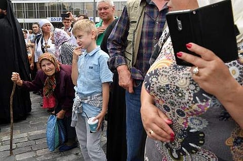 Believers of the Ukrainian Orthodox Church (Moscow patriarchy) look on as they take part in the many-thousand people religious procession in Kiev on July 27, 2018, marking 1030th anniversary of the Christianization of Kievan Rus. Ukraine also has two diss