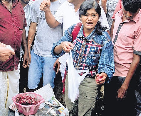 Hanan, a third year BSc Chemistry student, selling fish at Thammanam Junction on Thursday (Photo | EPS/A Sanesh)