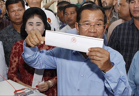 Cambodian Prime Minister Hun Sen holds his ballot at a polling station in Takhmua, Kandal province, southeast of Phnom Penh, Cambodia, Sunday, July 29, 2018. (Photo | AP)
