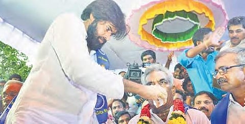 Jana Sena chief Pawan Kalyan offering lemon juice to the farmers protesting against land acquisition at Uddandarayunipalem on Saturday | Express