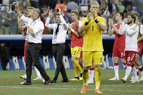 Denmark head coach Age Hareide, left, and his players applaud supporters team after the round of 16 match between Croatia and Denmark at the 2018 soccer World Cup in the Nizhny Novgorod Stadium, in Nizhny Novgorod. | AP