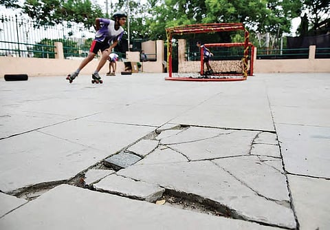 Children practicing on a skating rink that is chipped off at various places at LB Stadium;
