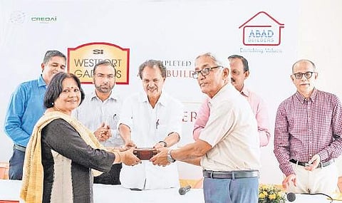 Keys being handed over to the owner of one of the flats of West Fort Gardens