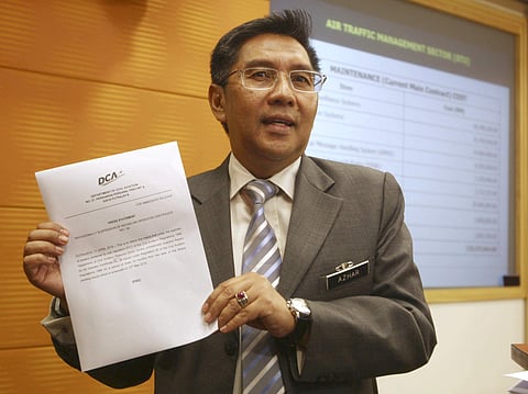Azharuddin Abdul Rahman, chairman of Civil Aviation Authority of Malaysia, shows a statement to the media during a press conference in Putrajaya, Malaysia. The civil aviation chief said Tuesday, July 31, 2018, he resigned to take responsibility after an i