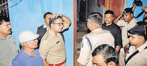 Police officers at the house where seven of a family were found dead| PTI