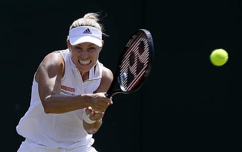 Angelique Kerber of Germany returns the ball to Vera Zvonareva of Russia during their women's singles match on the second day at the Wimbledon Tennis Championships in London.|AP