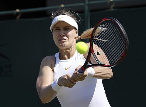 Eugenie Bouchard returns a shot to Gabriella Taylor during their women's singles match on the second day at the Wimbledon Tennis Championships in London. | AP