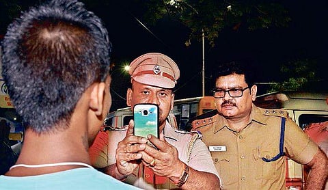 Police personnel taking picture using the ‘Facetagr App’ | Nakshatra Krishnamoorthy