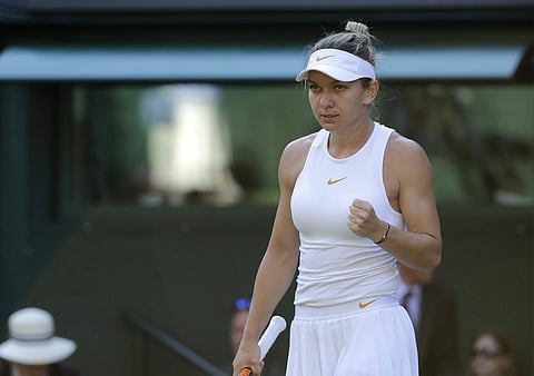 Simona Halep celebrates defeating Kurumi Nara in their women's singles match, on the second day of the Wimbledon Tennis Championships in London. | AP
