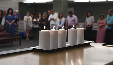 Employees stand for a moment of silence in the Baltimore Sun newsroom, Thursday July 5, 2018, in Baltimore, Md., for the five colleagues of the Capital Gazette in Annapolis, Md., who were killed a week ago in one of the deadliest attacks on journalists in