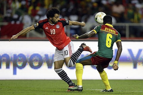 In this Sunday, Feb. 5, 2017 file photo, Egypt's Mohamed Salah, left, controls the ball in front of Cameroon's Ambroise Oyongo during the African Cup of Nations final. | AP