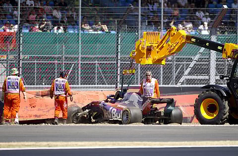 Brendon Hartley's Toro Rosso car is removed from the track after crashing out during third free practice at the Silverstone racetrack, Silverstone. | AP
