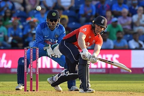 England's Eoin Morgan (R) bats as India's MS Dhoni keeps wicket during the second T20 match between England and India at Sophia Gardens in Cardiff, south Wales, on July 6, 2018. | AFP