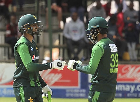 Pakistan's Fakhar Zaman, left, gestures with Shoaib Malik during the T20 cricket match between Australia and Pakistan at the Harare Sports Club, in Harare. (AP)
