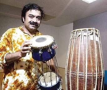 Kuzhalmannam Ramakrishnan with his traditional and new mridangam.