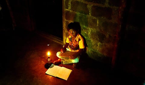 Kerala: A boy in a tribal hamlet in Kuttampuzha panchayat, in the outskirts of Ernakulam, bordering Idukki, studies under a kerosene lamp. (Photo | Albin Mathew/EPS)