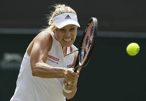 Angelique Kerber of Germany returns a ball to Belinda Bencic of Switzerland during their women's singles match on the seventh day at the Wimbledon Tennis Championships in London. (AP)