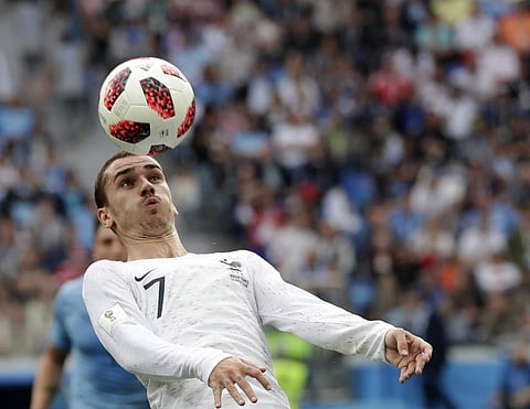France's Antoine Griezmann heads the ball during the quarterfinal match between Uruguay and France at the 2018 soccer World Cup in the Nizhny Novgorod Stadium. | AP