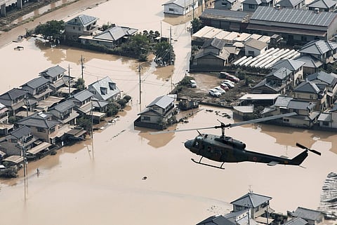 A helicopter flies over a flooded housing area in Kurashiki, Okayama prefecture, western Japan Monday, July 9, 2018. (Photo | AP)