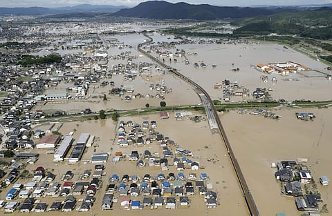 Houses are partly submerged in water, following heavy rain in Kurashiki city, Okayama prefecture, southwestern Japan, Sunday, July 8, 2018. Heavy rainfall hammered southern Japan for the third day, prompting new disaster warnings on Kyushu and Shikoku isl