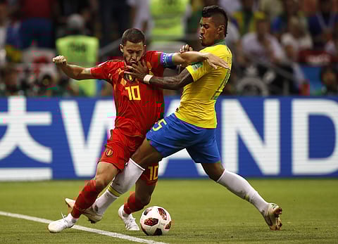 Belgium's Eden Hazard, left, and Brazil's Paulinho challenge for the ball during the quarterfinal match between Brazil and Belgium at the 2018 soccer World Cup in the Kazan Arena, in Kazan, Russia, Friday, July 6, 2018. | AP