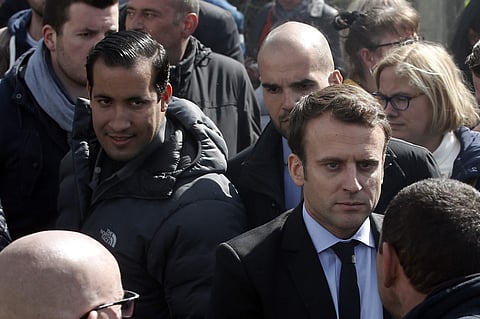 In this Wednesday April 26, 2017 file photo, Emmanuel Macron, right, is flanked by his bodyguard, Alexandre Benalla, left, outside the Whirlpool home appliance factory, in Amiens, northern France. | AP