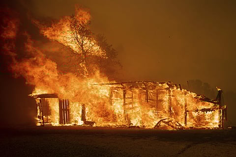 Flames consume a home as the River Fire tears though Lakeport, Calif. (Photo | AP)