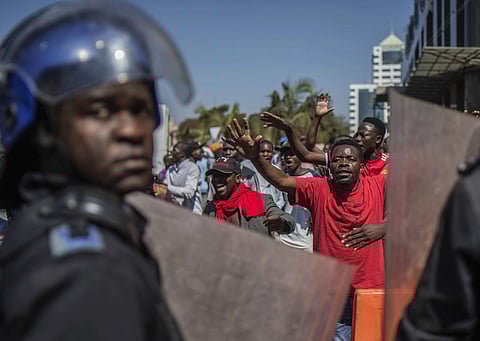 Police patrol outside the Zimbabwe Electoral Commission offices as opposition supporters gather, in Harare, Zimbabwe. (Photo | AP)