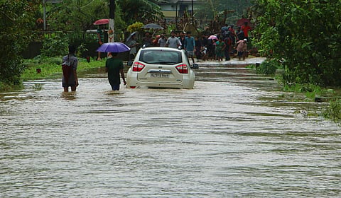 A vehicle passing through a submerged road at Neravilpuzha in Wayanad on Thursday. (Photo | TP Sooraj/EPS)