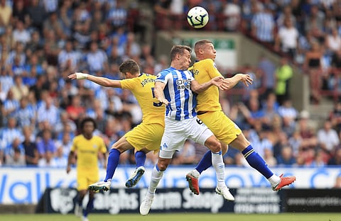 Huddersfield Town's Jonathan Hogg, centre, battles with Chelsea's Jorginho, left, and Ross Barkley during their English Premier League soccer match at the John Smith's Stadium in Huddersfield, England. (Photo | AP)