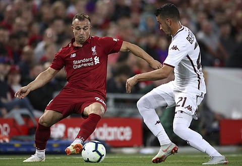 Liverpool's Xherdan Shaqiri, left, and Torino's Alex Berenguer battle for the ball during the pre-season soccer match between Torino and Liverpool at Anfield, Liverpoo, England, Tuesday, Aug. 7, 2018. | AP