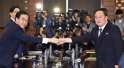 South Korean Unification Minister Cho Myoung-gyon, left, shakes hands with his North Korean counterpart Ri Son Gwon during their meeting at the northern side of Panmunjom in the Demilitarized Zone, North Korea. (Photo | AP)