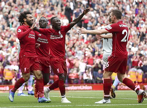 Liverpool's Mohamed Salah, left, celebrates scoring his side's first goal of the game during the Premier League soccer match between Liverpool and West Ham at Anfield, Liverpool, England. ( Photo | AP )