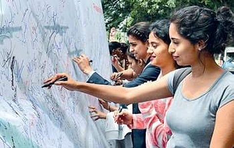 Mount Carmel College students at a signature campaign against move to shift Aero India from Bengaluru | PUSHKAR V