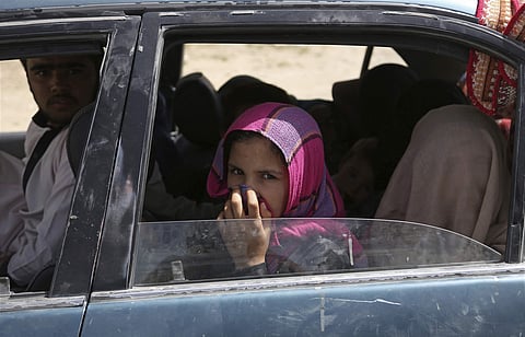 An Afghan family, who escaped from the volatile city of Ghazni, pose for a photograph in Maidan Shar, west of Kabul, Afghanistan, Monday, Aug. 13, 2018. (Photo | AP)